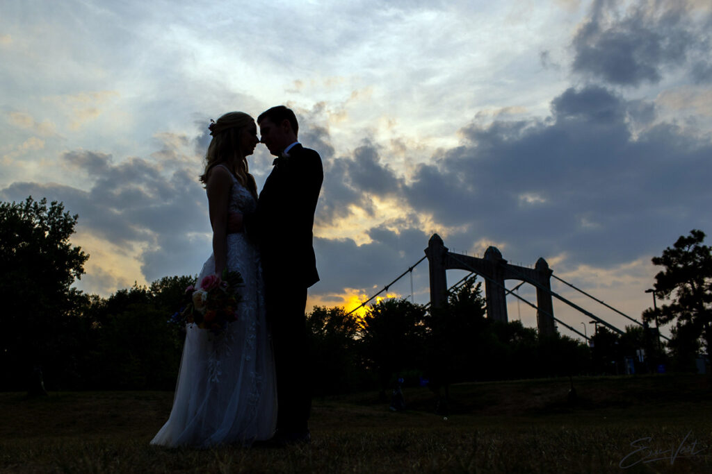 Bride and Groom at sunset with bridge in background